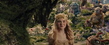 Movie still from “Maleficent” (2014), directed by Robert Stromberg – A young girl in a gold dress and a flower crown; Medium shot, Over the shoulder angle
