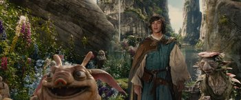 Movie still from “Maleficent” (2014), directed by Robert Stromberg – A man in a costume standing in front of an animal in a forest; Medium shot, Over the shoulder angle