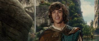 Movie still from “Maleficent” (2014), directed by Robert Stromberg – A young man with long brown hair wearing a brown cape; Close Up shot, Over the shoulder angle