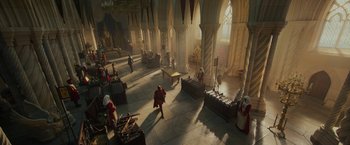 Movie still from “Maleficent: Mistress of Evil” (2019), directed by Joachim Rønning – A group of people standing in a room with a lot of furniture; Extreme Wide shot, High angle