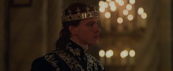 Movie still from “Maleficent: Mistress of Evil” (2019), directed by Joachim Rønning – A man wearing a crown and a black robe; Close Up shot, Over the shoulder angle