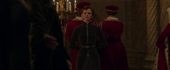 Movie still from “Maleficent: Mistress of Evil” (2019), directed by Joachim Rønning – A woman standing in front of a group of people; Medium shot, Over the shoulder angle