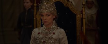 Movie still from “Maleficent: Mistress of Evil” (2019), directed by Joachim Rønning – A woman wearing a crown and wearing a necklace; Close Up shot, Over the shoulder angle
