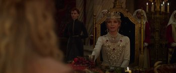 Movie still from “Maleficent: Mistress of Evil” (2019), directed by Joachim Rønning – A woman sitting in front of a mirror wearing a crown; Medium shot, Over the shoulder angle