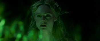 Movie still from “Maleficent: Mistress of Evil” (2019), directed by Joachim Rønning – A woman with long blonde hair wearing a green light; Close Up shot, High angle