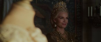 Movie still from “Maleficent: Mistress of Evil” (2019), directed by Joachim Rønning – A woman in a gold dress and a crown; Close Up shot, Over the shoulder angle