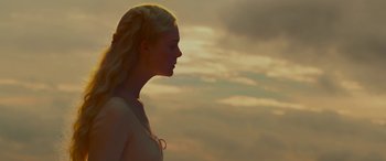 Movie still from “Maleficent: Mistress of Evil” (2019), directed by Joachim Rønning – A beautiful blonde woman standing in front of a cloudy sky; Close Up shot, Low angle