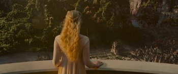 Movie still from “Maleficent: Mistress of Evil” (2019), directed by Joachim Rønning – A woman with long blonde hair looking out of a window; Wide shot, High angle