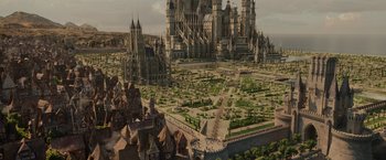 Movie still from “Maleficent: Mistress of Evil” (2019), directed by Joachim Rønning – An aerial view of a city with many buildings and trees; Extreme Wide shot, High angle