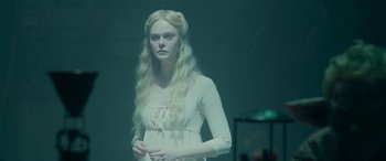 Movie still from “Maleficent: Mistress of Evil” (2019), directed by Joachim Rønning – A woman with long blonde hair wearing a white dress; Medium shot, Over the shoulder angle