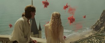 Movie still from “Maleficent: Mistress of Evil” (2019), directed by Joachim Rønning – Two people looking out over the water at a castle; Wide shot, High angle