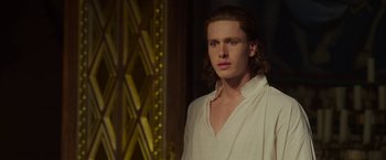 Movie still from “Maleficent: Mistress of Evil” (2019), directed by Joachim Rønning – A man with long hair wearing a white shirt; Close Up shot, Over the shoulder angle