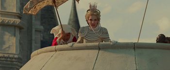 Movie still from “Maleficent: Mistress of Evil” (2019), directed by Joachim Rønning – Two women dressed in medieval costumes and holding an umbrella; Medium shot, Low angle