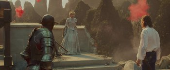 Movie still from “Maleficent: Mistress of Evil” (2019), directed by Joachim Rønning – A woman dressed as a princess standing on steps; Wide shot, Over the shoulder angle