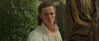 Movie still from “Maleficent: Mistress of Evil” (2019), directed by Joachim Rønning – A man with long brown hair wearing a white shirt; Close Up shot, Over the shoulder angle