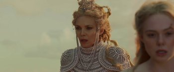 Movie still from “Maleficent: Mistress of Evil” (2019), directed by Joachim Rønning – A woman with long blonde hair wearing a crown; Close Up shot, Over the shoulder angle