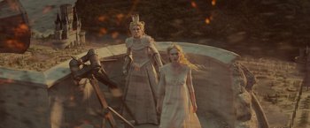 Movie still from “Maleficent: Mistress of Evil” (2019), directed by Joachim Rønning – Two women dressed in medieval costumes standing next to a wall; Wide shot, High angle