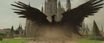 Movie still from “Maleficent: Mistress of Evil” (2019), directed by Joachim Rønning – An image of an angel with a large black bird wings in front of a castle; Extreme Wide shot, Low angle