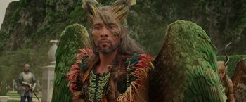 Movie still from “Maleficent: Mistress of Evil” (2019), directed by Joachim Rønning – A man in a costume is standing in the woods; Close Up shot, High angle