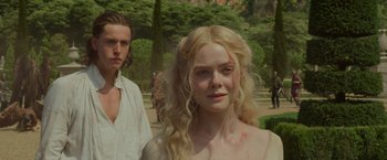 Movie still from “Maleficent: Mistress of Evil” (2019), directed by Joachim Rønning – A woman with long blonde curly hair standing next to a man with long blond hair; Close Up shot, Over the shoulder angle