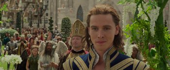 Movie still from “Maleficent: Mistress of Evil” (2019), directed by Joachim Rønning – A group of people in costumes in a parade; Close Up shot, Over the shoulder angle