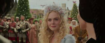 Movie still from “Maleficent: Mistress of Evil” (2019), directed by Joachim Rønning – A woman with long blonde hair wearing a flower crown; Close Up shot, Over the shoulder angle