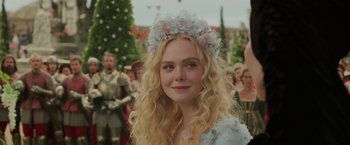Movie still from “Maleficent: Mistress of Evil” (2019), directed by Joachim Rønning – A beautiful young lady with long blonde hair wearing a flower crown; Close Up shot, Over the shoulder angle