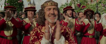 Movie still from “Maleficent: Mistress of Evil” (2019), directed by Joachim Rønning – A group of men in medieval garb clapping in front of each other; Close Up shot, Low angle