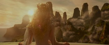 Movie still from “Maleficent: Mistress of Evil” (2019), directed by Joachim Rønning – A woman with long blonde curly hair wearing a flower crown; Medium shot, Over the shoulder angle