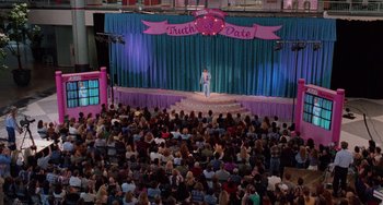 A man standing in front of an audience in front of a crowd