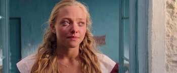 Movie still from “Mamma Mia!” (2008), directed by Phyllida Lloyd – A person with long blonde hair; Close Up shot, Over the shoulder angle