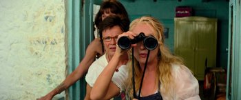 Movie still from “Mamma Mia!” (2008), directed by Phyllida Lloyd – A group of women looking through binoculars; Medium shot, High angle