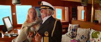 Movie still from “Mamma Mia!” (2008), directed by Phyllida Lloyd – An old man in a captain's uniform holding a hammer; Medium shot, Over the shoulder angle