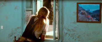 Movie still from “Mamma Mia!” (2008), directed by Phyllida Lloyd – A woman looking out of a window at a cat; Medium shot, Over the shoulder angle