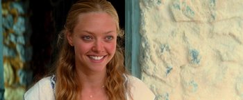 Movie still from “Mamma Mia!” (2008), directed by Phyllida Lloyd – A person with a smile on their face; Close Up shot, Over the shoulder angle