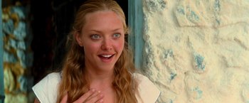 Movie still from “Mamma Mia!” (2008), directed by Phyllida Lloyd – A person with long blonde hair; Close Up shot, Over the shoulder angle