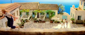 Movie still from “Mamma Mia!” (2008), directed by Phyllida Lloyd – A painting of a house with a garden in front of it; Extreme Wide shot, High angle