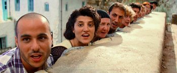 Movie still from “Mamma Mia!” (2008), directed by Phyllida Lloyd – A group of people standing next to each other; Medium shot, Overhead angle