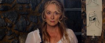 Movie still from “Mamma Mia!” (2008), directed by Phyllida Lloyd – A person with long hair; Close Up shot, Low angle