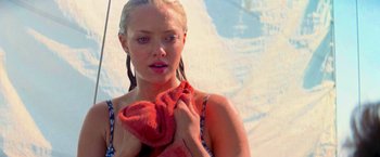 Movie still from “Mamma Mia!” (2008), directed by Phyllida Lloyd – A young woman holding a towel in her hands; Close Up shot, Low angle