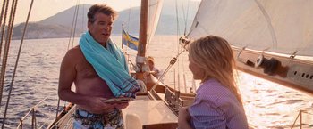 Movie still from “Mamma Mia!” (2008), directed by Phyllida Lloyd – A man and a woman on a sail boat in the ocean; Medium shot, Over the shoulder angle