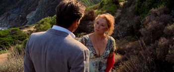 Movie still from “Mamma Mia!” (2008), directed by Phyllida Lloyd – A man and a woman are standing in a field; Close Up shot, Over the shoulder angle