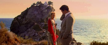 Movie still from “Mamma Mia!” (2008), directed by Phyllida Lloyd – A man and a woman standing next to each other on a cliff; Medium shot, Over the shoulder angle