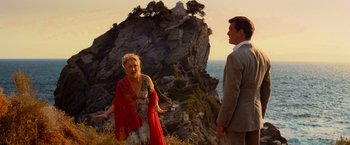 Movie still from “Mamma Mia!” (2008), directed by Phyllida Lloyd – A man and a woman standing next to each other on top of a hill; Wide shot, Over the shoulder angle