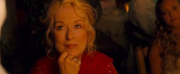 Movie still from “Mamma Mia!” (2008), directed by Phyllida Lloyd – A person wearing a red shirt; Close Up shot, Over the shoulder angle