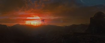 Movie still from “Man of Steel” (2013), directed by Zack Snyder – The sun is setting over the mountains with a ship in the background; Extreme Wide shot, Low angle