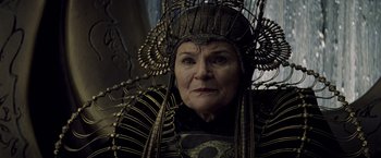Movie still from “Man of Steel” (2013), directed by Zack Snyder – An older woman wearing a headdress and a black jacket; Close Up shot, Over the shoulder angle