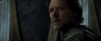 Movie still from “Man of Steel” (2013), directed by Zack Snyder – A person with a beard looking at the camera; Close Up shot, Low angle