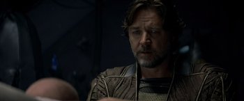 Movie still from “Man of Steel” (2013), directed by Zack Snyder – A person wearing a suit and tie; Close Up shot, Over the shoulder angle