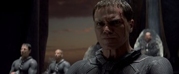 Movie still from “Man of Steel” (2013), directed by Zack Snyder – A man with a scar on his face is looking into the camera; Close Up shot, Low angle
